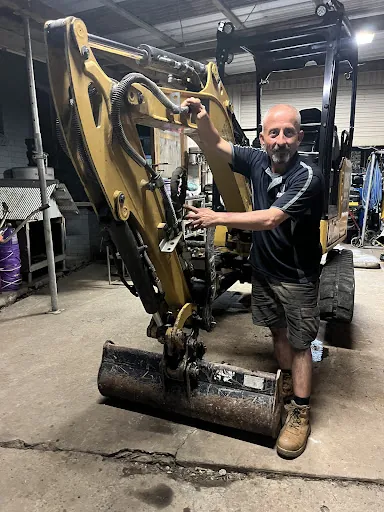 A mini excavator in a workshop