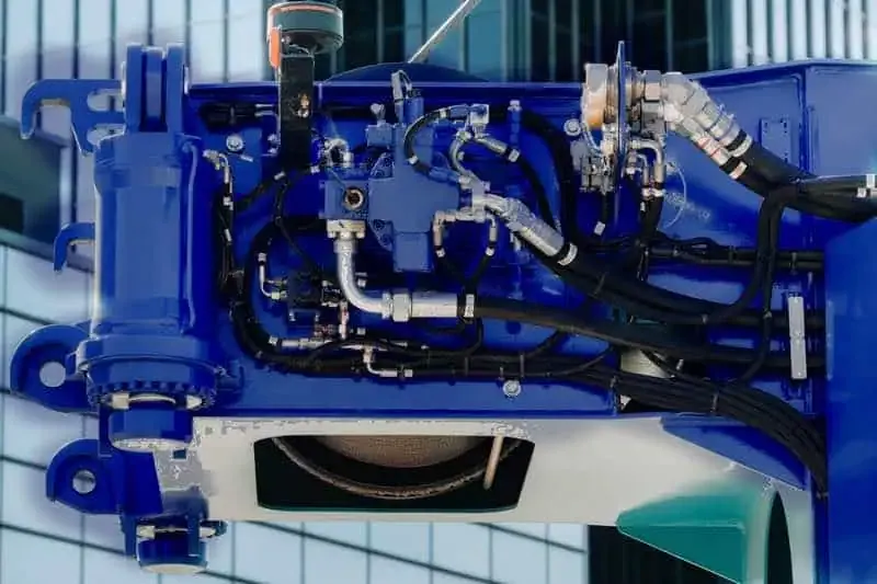 Blue hydraulic machine with hoses and fittings