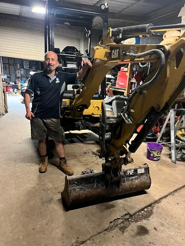 Compact excavator in the workshop