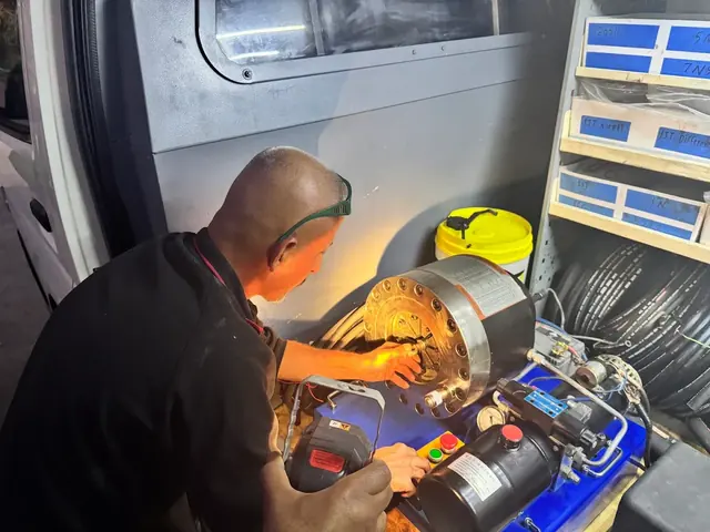 Working on a hydraulic power unit in the van