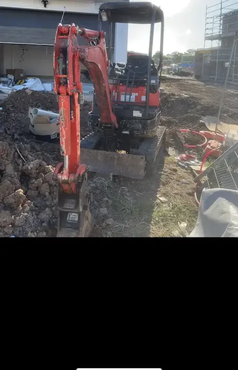 Compact excavator on site
